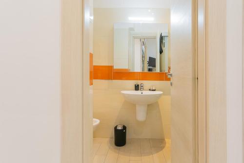 a bathroom with a sink and a toilet and a mirror at Il borgo incantato in Bitonto