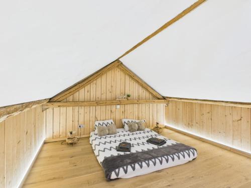 a bedroom with a large bed in a room at Sam's Cottage Suite in Niederweis
