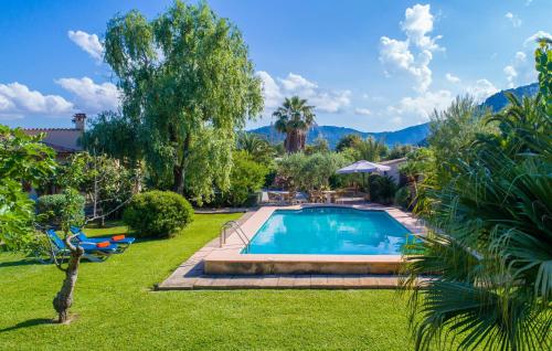 a swimming pool in a yard with grass and trees at Can Bleio in Pollença
