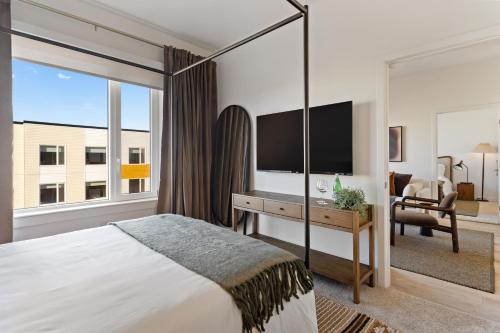 a bedroom with a large bed and a large window at Hyatus Luxury Residences Boston Everett Premier Collection in Everett