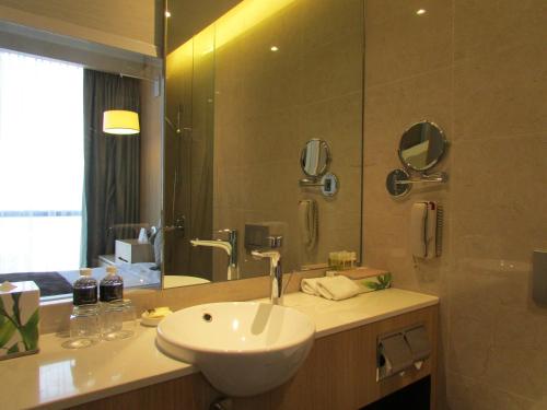 a bathroom with a sink and a mirror at Park Hotel Alexandra in Singapore