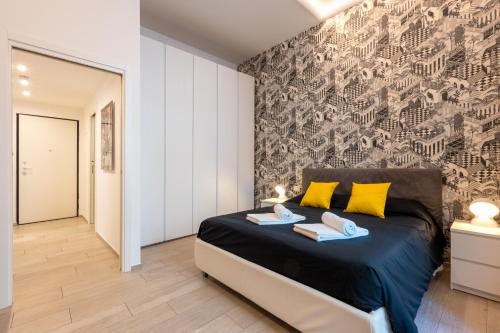 a bedroom with a large bed with yellow pillows at InLuce Terrazza in Sanremo
