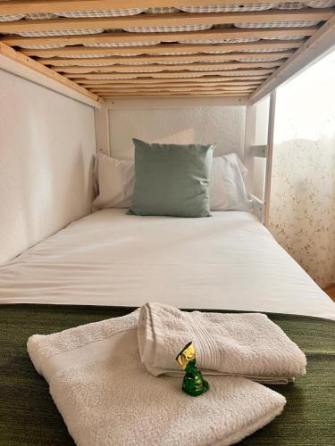 a bed with a pillow and a towel on it at Navarubia in Navacerrada