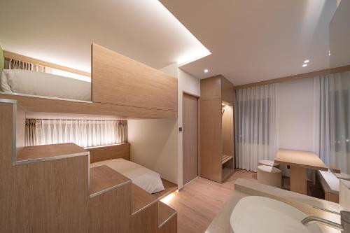 a small room with a bed and a staircase at 하로스테이 신사점 in Seoul