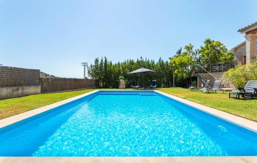 a large blue swimming pool in a yard at Turixant Dalt in El Port de la Selva