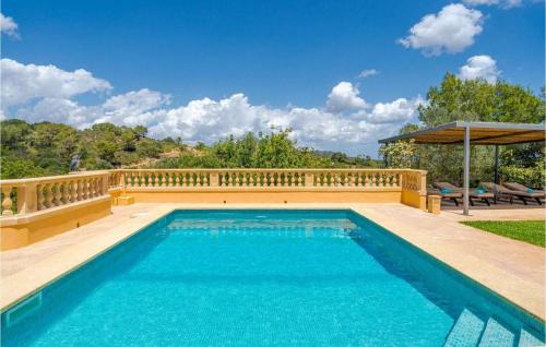 a swimming pool with a wooden fence around it at Es Socorrat in Portocolom