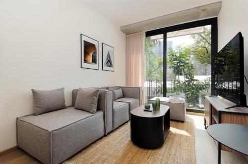 a living room with a couch and a table at Sullivan by Wynwood House in Mexico City