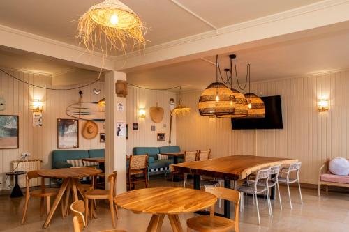 a restaurant with wooden tables and chairs in a room at WOT Ocean Soul in Sintra