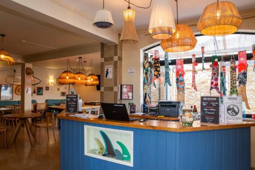 a restaurant with a bar with a laptop on a counter at WOT Ocean Soul in Sintra