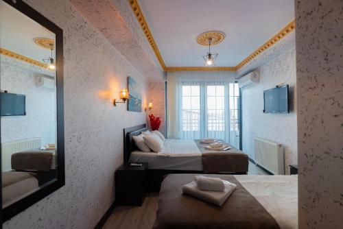 a hotel room with two beds and a mirror at Golden Horn Park Hotel in Istanbul