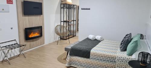 a bedroom with a bed and a fireplace at NS Bolaños in Bolaños de Calatrava