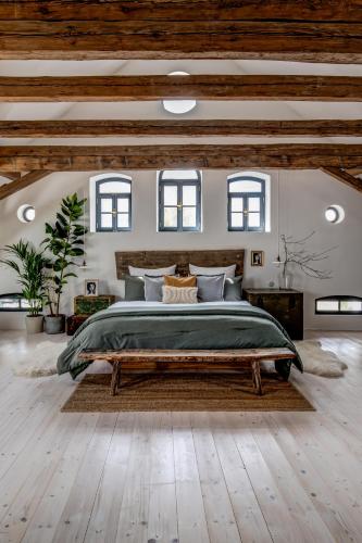 a large bedroom with a large bed and some windows at Darmyšl No13 in Staré Sedlo