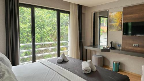 a bedroom with a bed and a large window at QUEEN PALACE HOTEL TRABZON in Trabzon