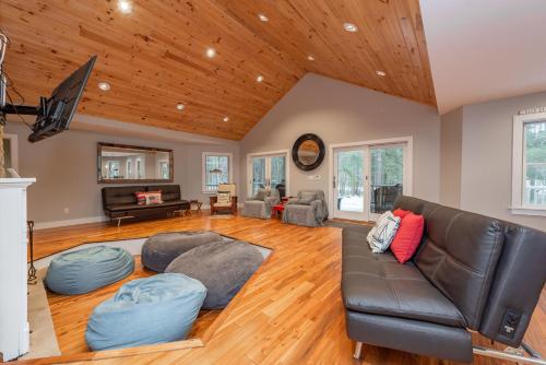 a living room with a couch and a tv at Wake Up Grateful by Railey Vacations in Swanton