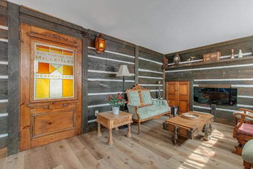 a living room with wood paneled walls and a door at auxportesdesMilleIles in Laval