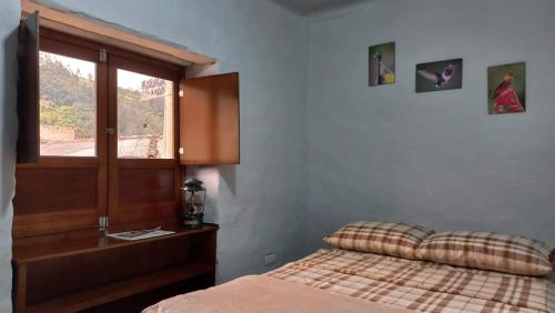 a bedroom with a bed and a window at Casa turística la Nativa in Puracé