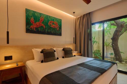 a bedroom with a bed and a large window at Hotel Compartir in Brisas de Zicatela