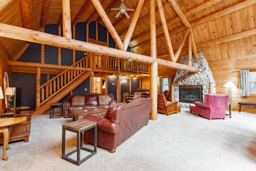 a living room filled with furniture and a fireplace at Viva By The Stream by Railey Vacations in McHenry
