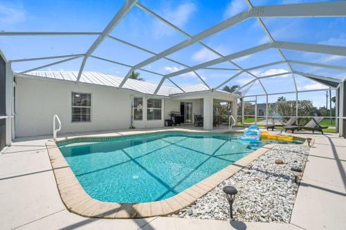 a swimming pool in a house with a glass roof at Villa Yvonne in Cape Coral