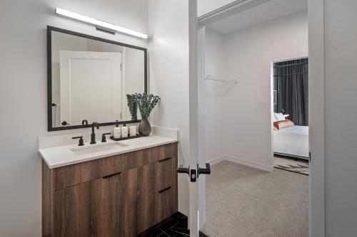 a bathroom with a sink and a mirror at Hyatus Luxury Residences Boston Everett Signature Collection in Everett