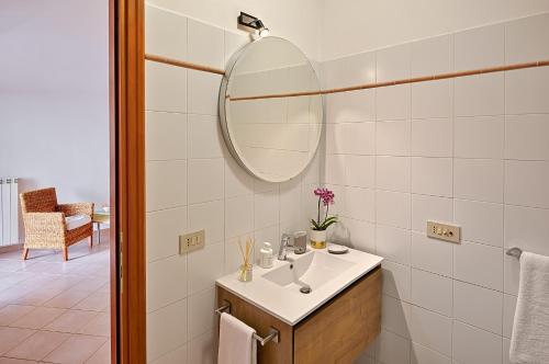 a bathroom with a sink and a mirror at Parasio - Mareri apartments in Imperia