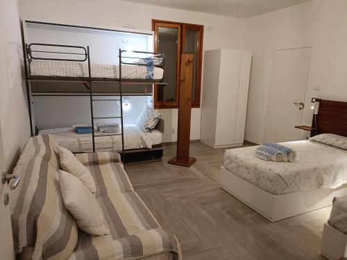 a bedroom with two bunk beds and a couch at B&B Zvana's - Da Giovanna in Imola