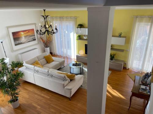 a living room with a white couch and a chandelier at Casa Riviera in Lavagna