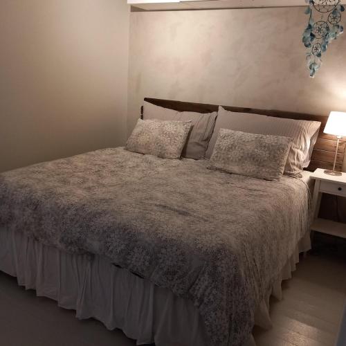 a bedroom with a bed and a table with a lamp at Central functional apartment with short distance to everything in Sandefjord