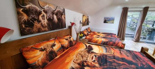 a bedroom with two beds with animals on them at Windsor Cottage on The Big "W" Ranch in Nether Wasdale