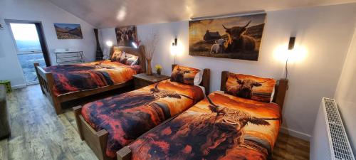 a room with two beds with animals on them at Windsor Cottage on The Big "W" Ranch in Nether Wasdale