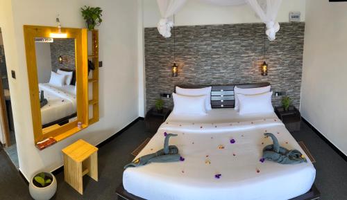 a bedroom with a large bed with two swans on it at Ella Forest Eco View in Ella
