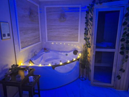 a bathroom with a tub with lights in it at Spa Apartman Banja Luka in Banja Luka