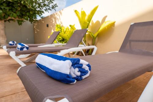 a blue and white towel sitting on a chair at Villa Beso in San Antonio