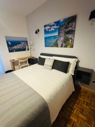 a bedroom with a large bed and a desk at My Way Rooms - Affittacamere in centro Trieste in Trieste
