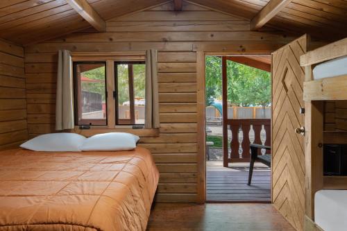a bedroom with a bed in a wooden house at Sun Outdoors Arches Gateway in Moab