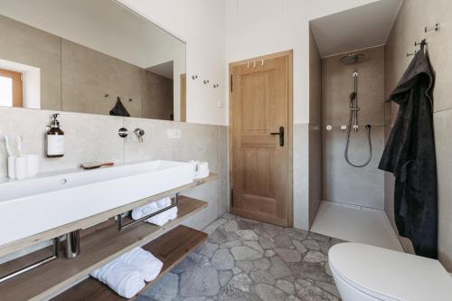 a bathroom with a sink and a toilet and a shower at Chalet Hafling Leckplått in Avelengo