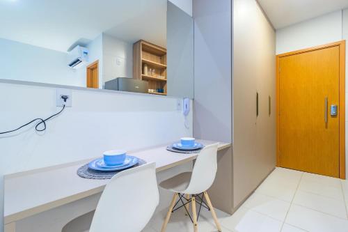 a kitchen with a table and two chairs at Mana Beach Experience Muro Alto By Carpediem in Porto De Galinhas