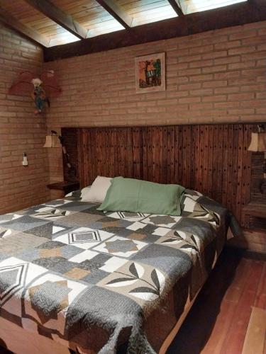 a bedroom with a large bed in a brick wall at soy ahora segunda in San Javier