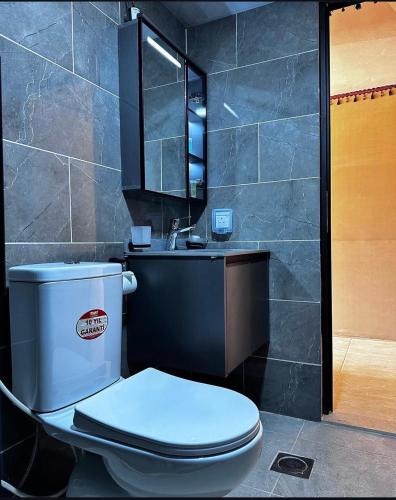 a bathroom with a white toilet and a sink at Nebula Rum Camp in Wadi Rum