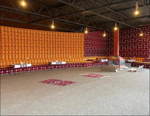 a large auditorium with orange walls and a stage at Nebula Rum Camp in Wadi Rum