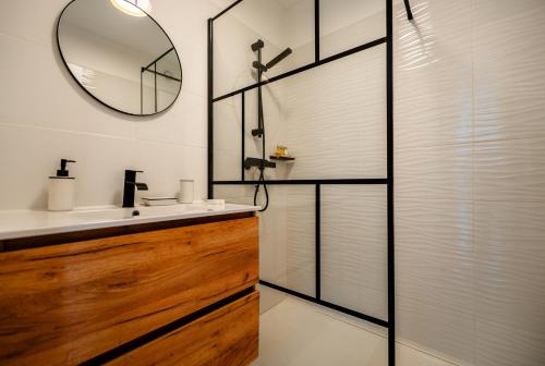 a bathroom with a sink and a mirror at Studio vue Mer Alegria in Sainte-Maxime