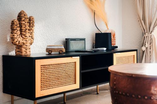 a black and gold dresser with a table at Studio vue Mer Alegria in Sainte-Maxime