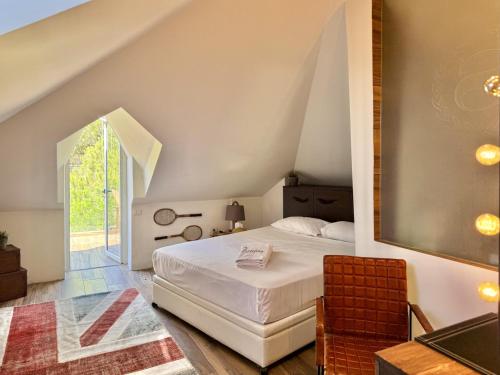 a bedroom with a white bed in a attic at Deluxe Loft at Monteverde in Beit Meri