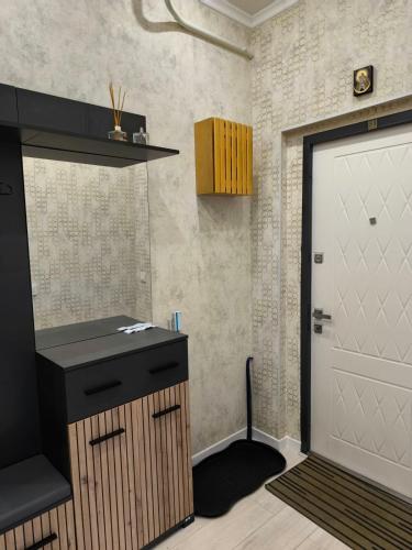 a kitchen with a white door and a black counter at Апарт-Отель Rozi in Svalyava