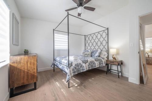 a bedroom with a canopy bed and a table at Spacious Boho Retreat Heated Pool-HotTub-Huge Yard in Tampa