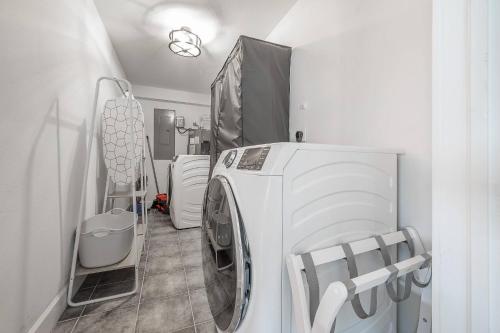 a laundry room with a washer and dryer at Spacious Boho Retreat Heated Pool-HotTub-Huge Yard in Tampa