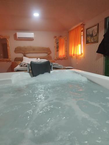a bath tub filled with water in a room at Drina in Pale