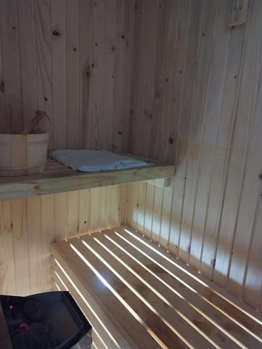 a sauna with a wooden paneled wall and a shelf at Drina in Pale
