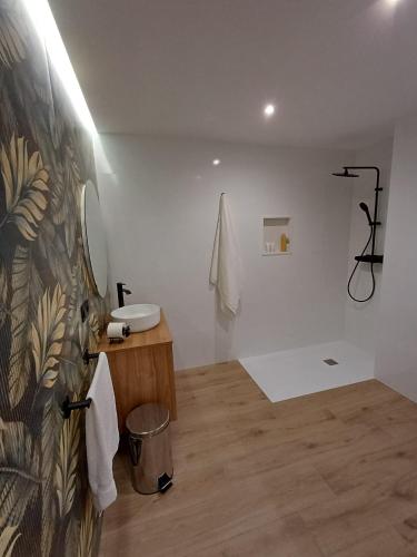 a white bathroom with a sink and a mirror at Apartamentos Porta do Espolón in Noya