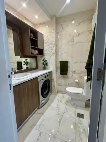 a bathroom with a washing machine and a toilet at Sharm Sea View - Sunny Beach in Sharm El Sheikh